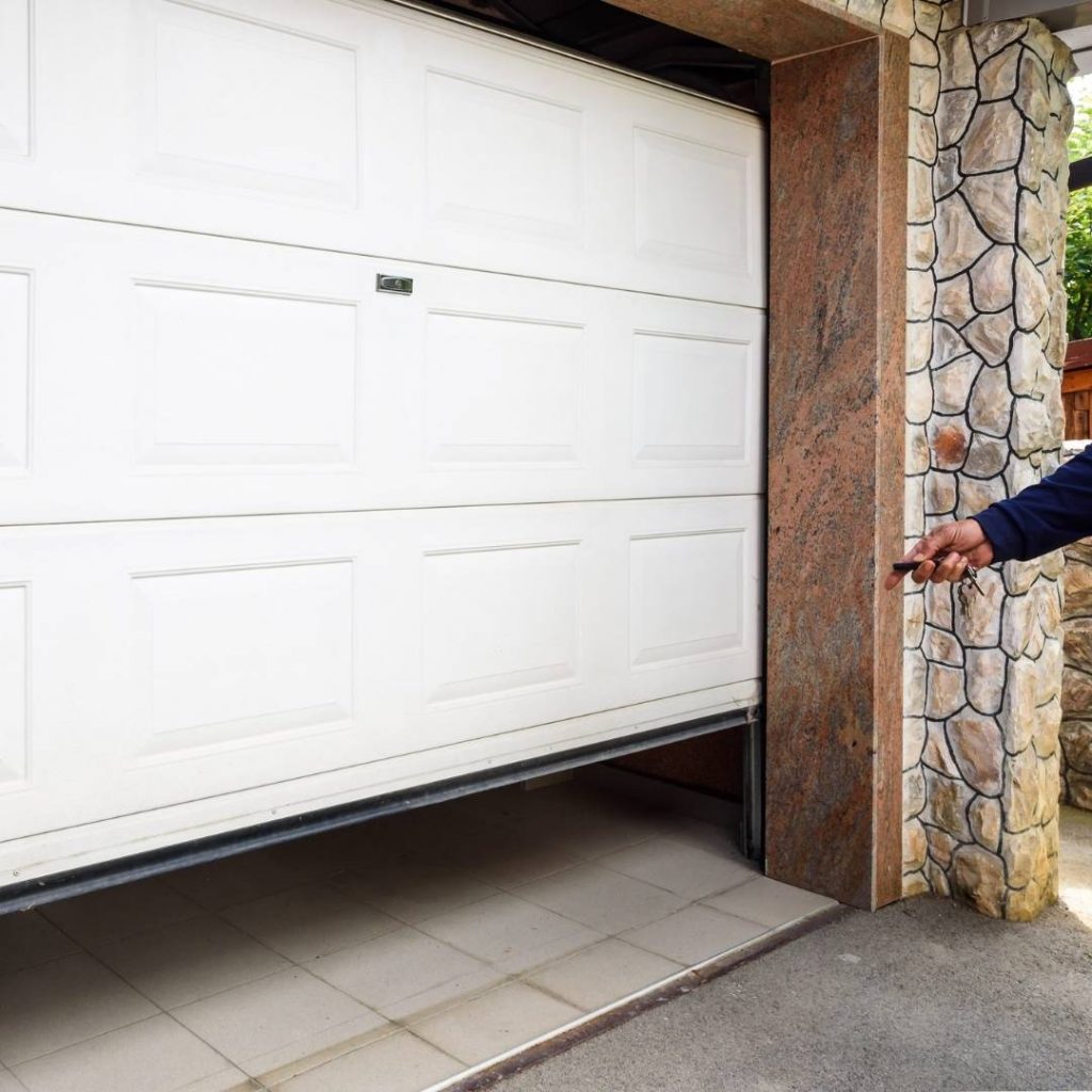 Close up of a garage door being opened with a remote control