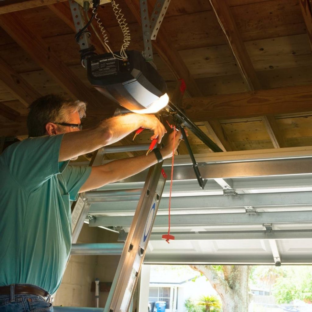 Technician installing a garage door opener