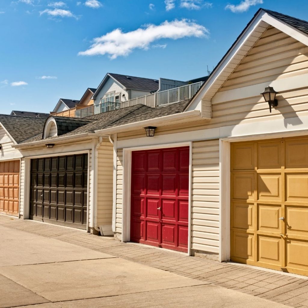 a cluster of houses with varying garage door colors